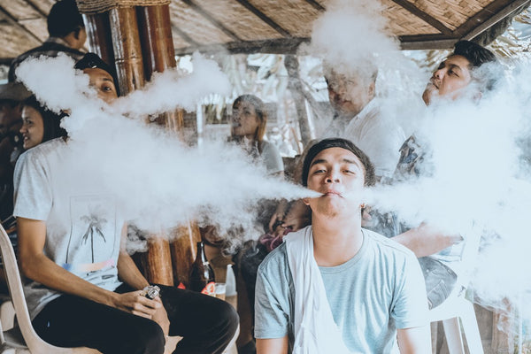 male vaping around friends