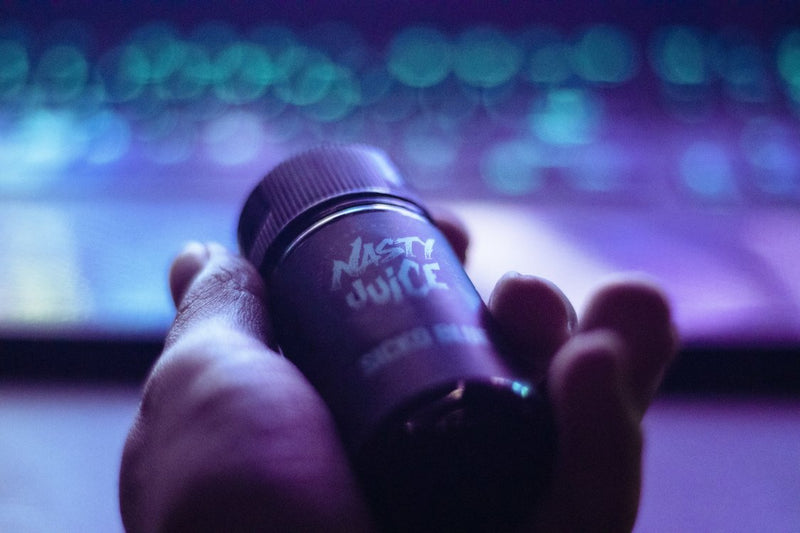 purple vape e-liquid in hand